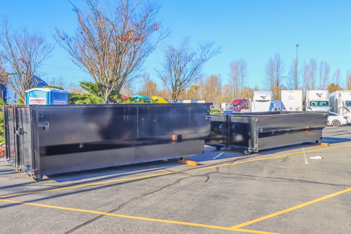 Professional dumpster rental service with roll-off container on residential driveway in Johnson Lane